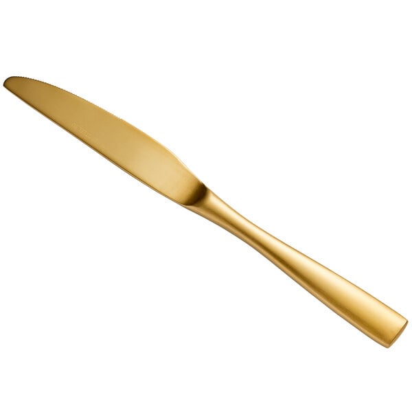 a gold knife on a white background