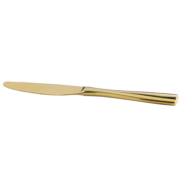 A close up of a Bon Chef gold stainless steel dinner knife with a long blade and handle.