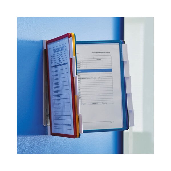 A Durable wall-mounted reference system with file folders and papers attached.