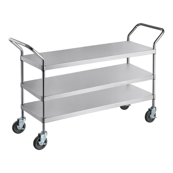 A stainless steel utility cart with three shelves and four caster wheels.
