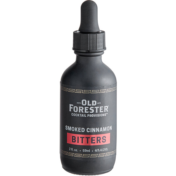 A close-up of a black Old Forester Smoked Cinnamon Bitters bottle with a dropper.