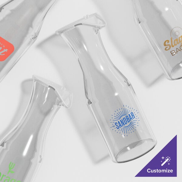 A clear plastic container with a yellow logo and the words "Customizable Polycarbonate Wine / Juice Decanter" in black.