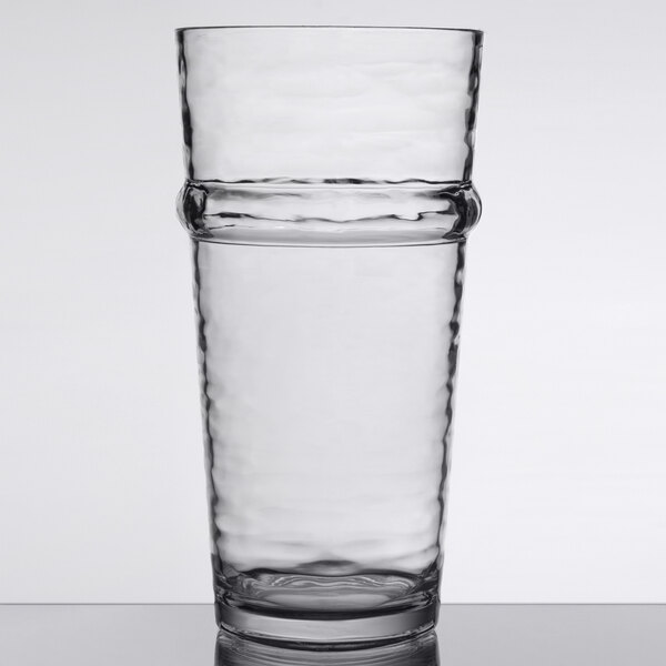 A Libbey Tritan plastic stackable cooler glass of water on a table.