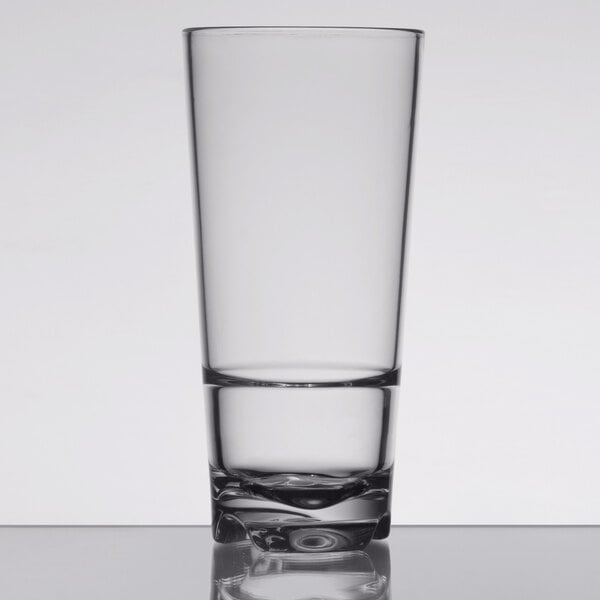 A close up of a Libbey Tritan plastic beverage glass filled halfway with a clear drink.