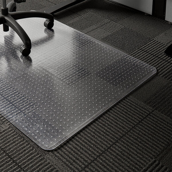 A clear plastic ES Robbins chair mat on a black carpet.