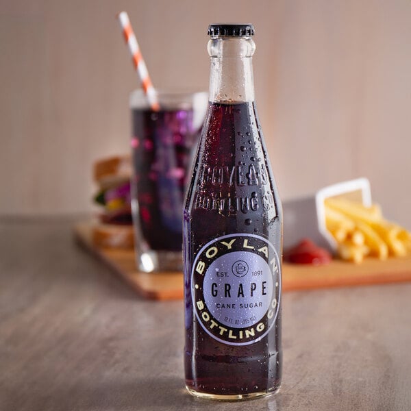 A close-up of a Boylan Grape Soda bottle with a label.