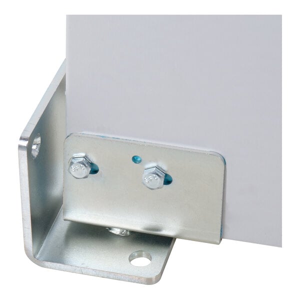A close-up view of a metal bracket secured with bolts to a flat surface, likely used for structural support or mounting.
