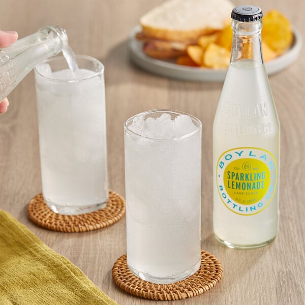 A hand pouring Boylan Bottling Co. Sparkling Lemonade into a glass.