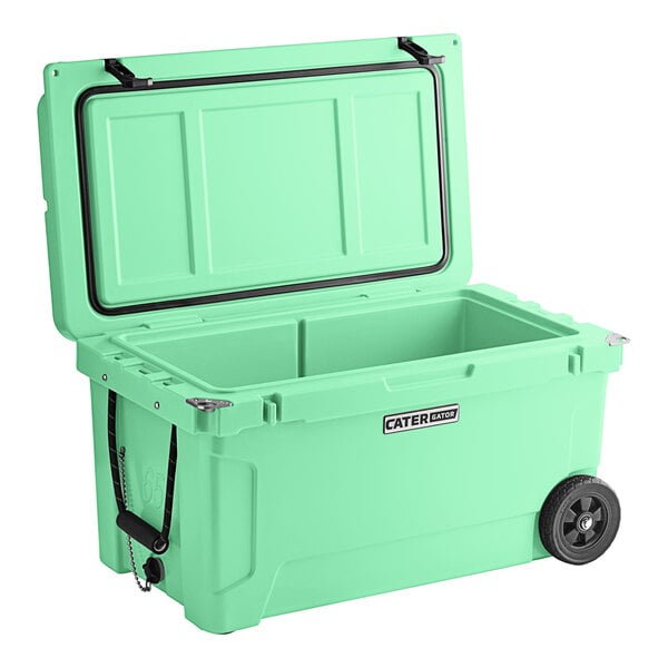 A seafoam green CaterGator outdoor cooler with wheels.