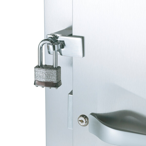 The stainless steel door of a Traulsen Correctional Roll-In Heated Holding Cabinet with a padlock on it.