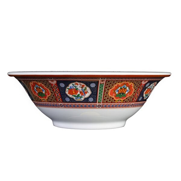 A close-up of a Thunder Group Peacock melamine bowl with colorful designs.