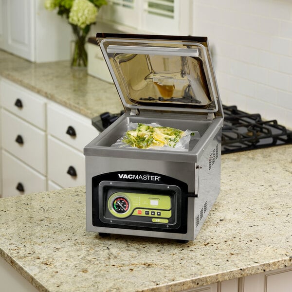 An ARY VacMaster VP210 tabletop vacuum packaging machine on a counter.