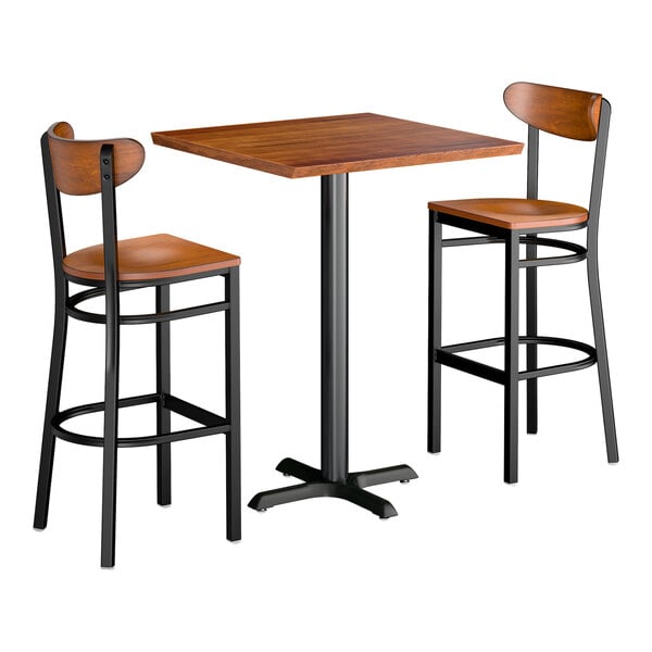 A 30-inch square rustic walnut solid wood bar height table with two matching boomerang bar stools.