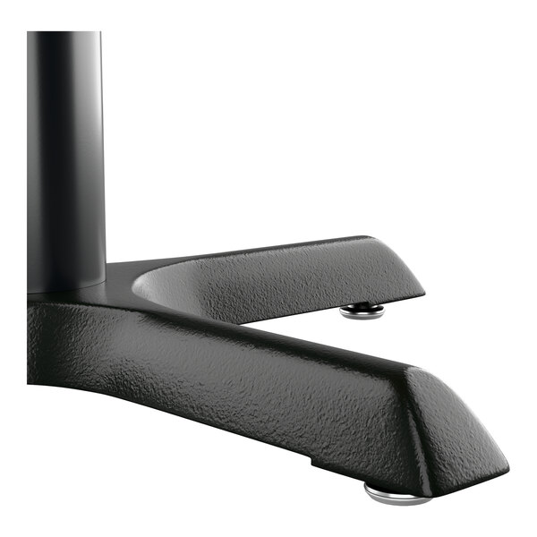 A close-up view of a black metal table base with adjustable feet.
