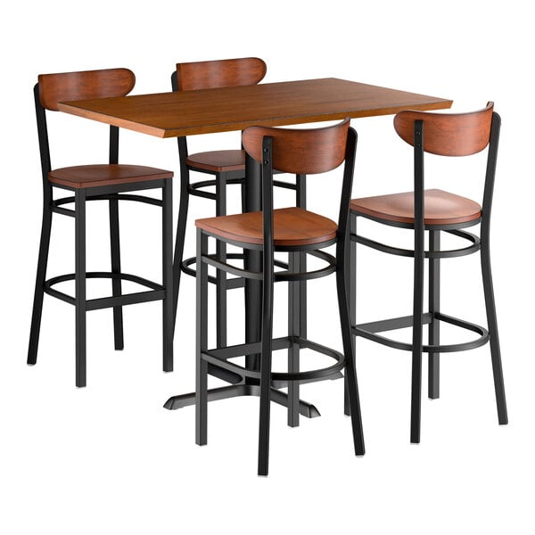A bar-height dining set featuring a rectangular wooden table with a rustic walnut finish and four matching bar stools with wooden seats and backs, all supported by black metal frames.