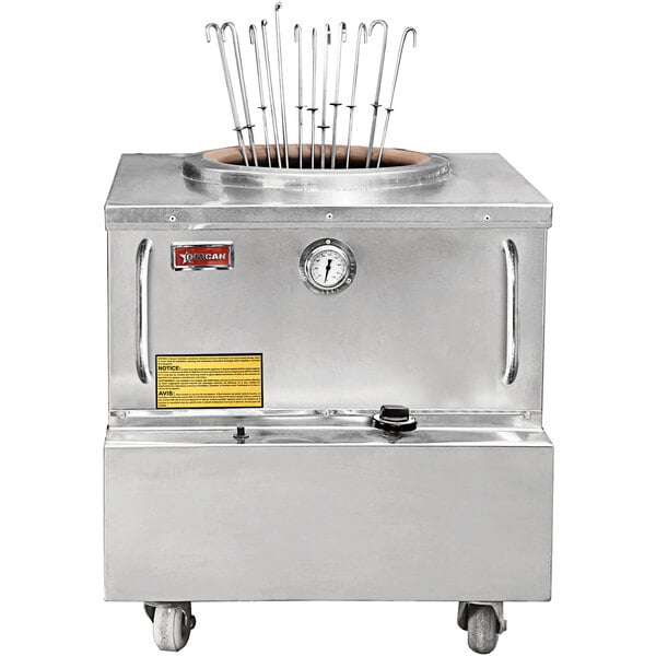 A large stainless steel Baba Clay Tandoor Oven with a metal rack on top.