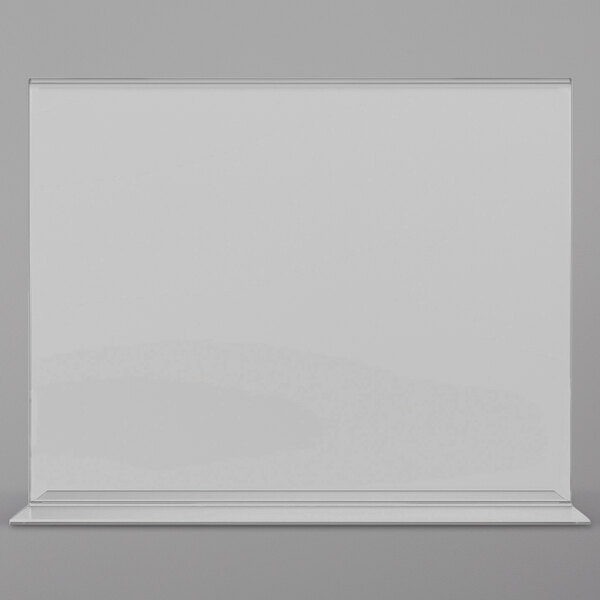 A clear Deflecto double-sided sign holder on a grey surface.