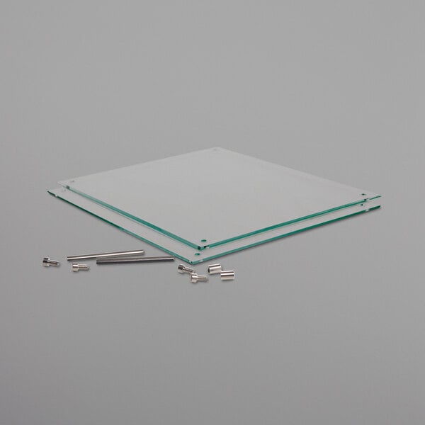 A Deflecto glass panel with clear edges and screws.