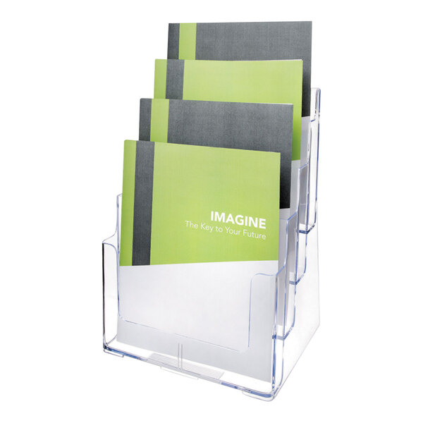 A clear, four-compartment magazine holder displaying several green and gray booklets.