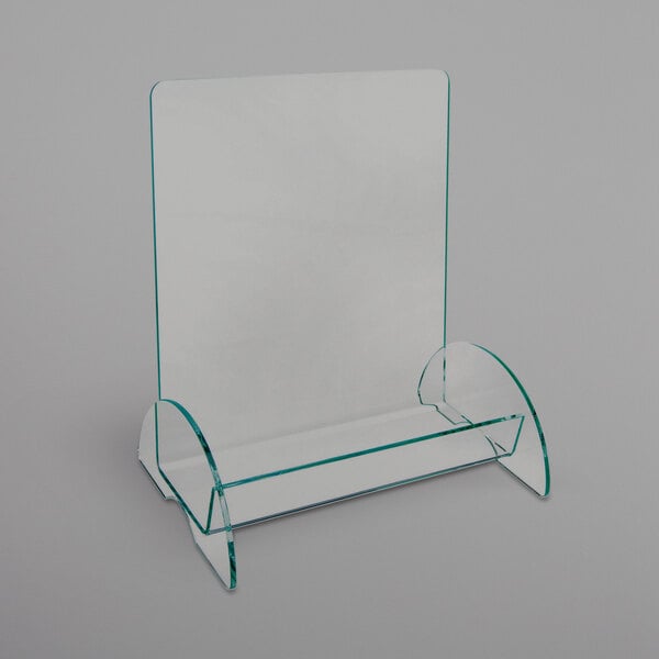 A clear acrylic display stand with a single compartment for magazines.