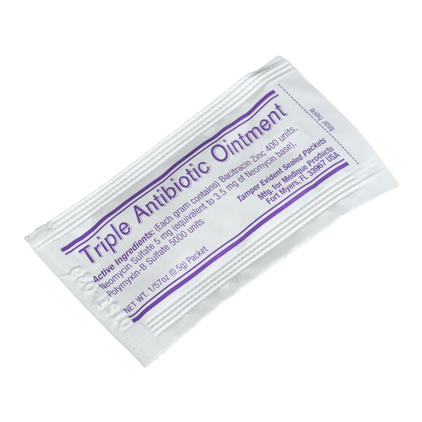 A close-up of a Medi-First antibiotic cream packet with purple text.
