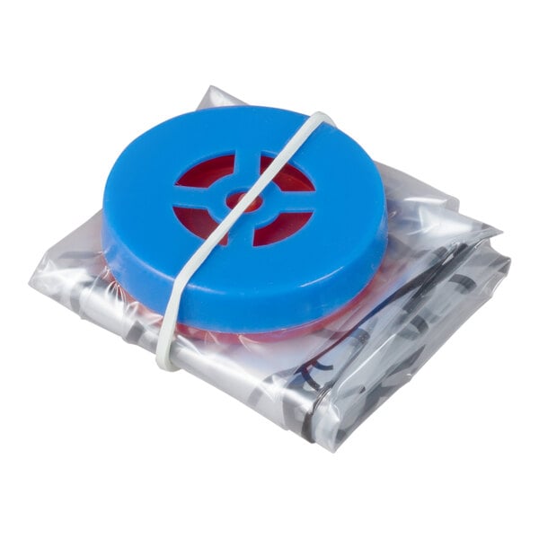 A folded plastic sheet with a blue circular component, secured by a white rubber band.