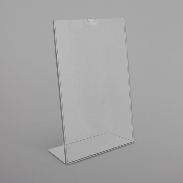 A clear plastic Deflecto slanted sign holder on a white surface.