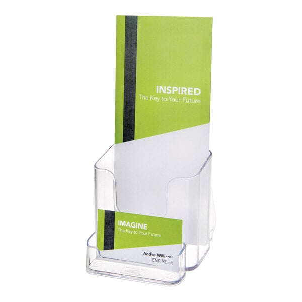 A clear, upright brochure holder with a front pocket containing a business card, displaying a green and white brochure.