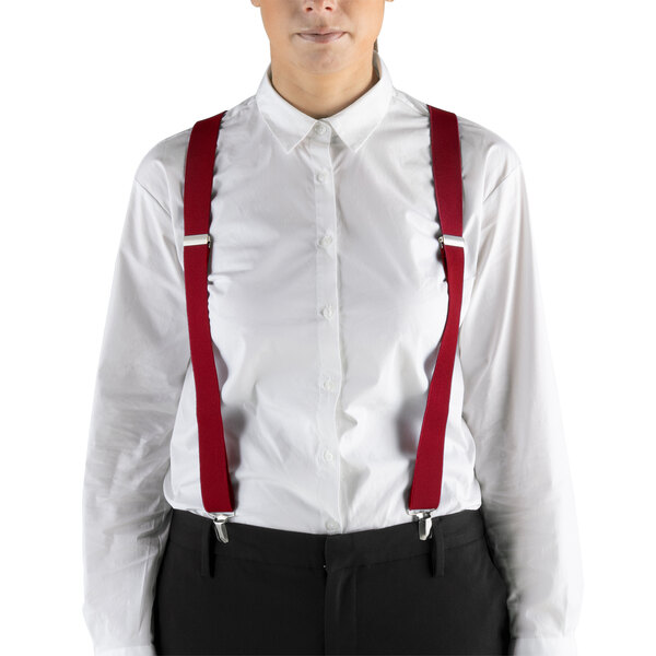 A woman wearing Henry Segal red clip-end suspenders over a white shirt.