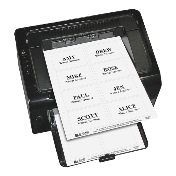 A printer is printing a sheet of white adhesive name badges with black text, each badge displaying a name and the words 'Winter Seminar.'