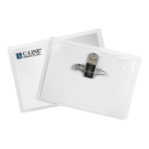 Two clear plastic name badge holders are shown, one displaying a metal clip and pin attachment on the back, and the other showing a paper insert with a logo visible through the front.