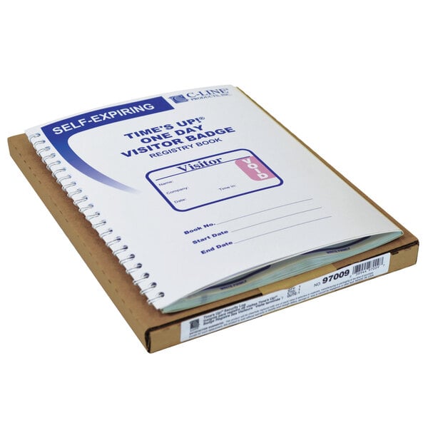 A white spiral bound notebook with a stack of paper on top.