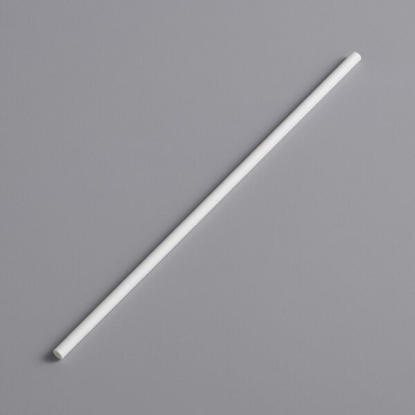 An EcoChoice white paper straw on a gray surface.