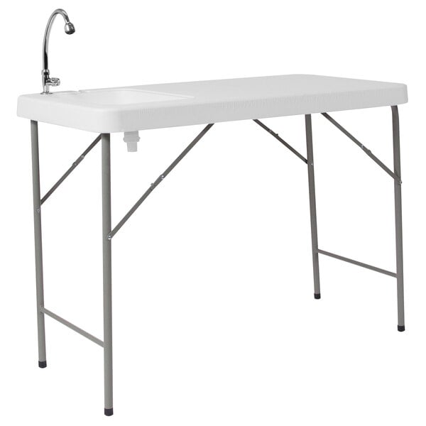 A white rectangular Flash Furniture folding table with a sink and faucet.