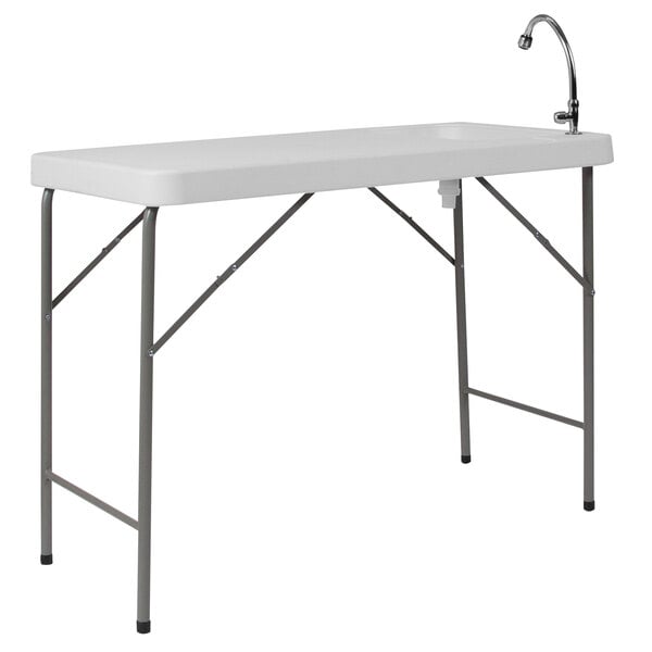 A white rectangular Flash Furniture folding table with a sink and faucet.