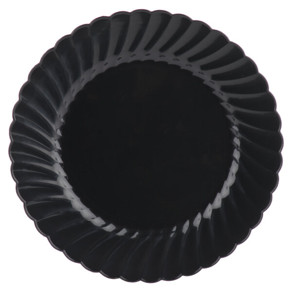 A black plastic plate with a scalloped edge and a swirly design.