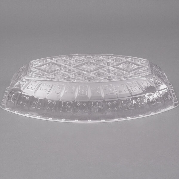 A close-up of a Fineline crystal clear plastic bowl with a design on it.