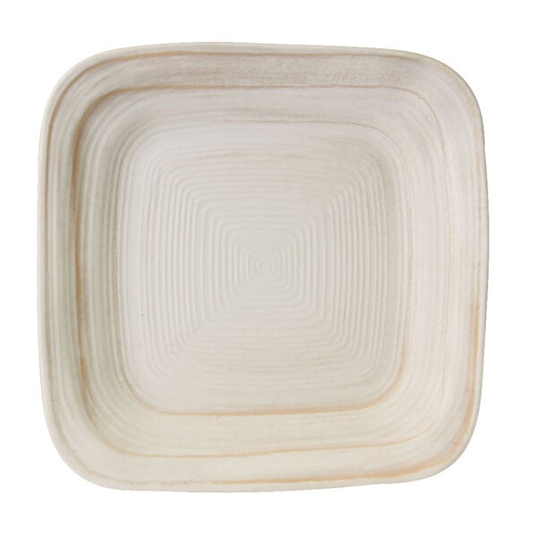 An off white square plate with a white border.