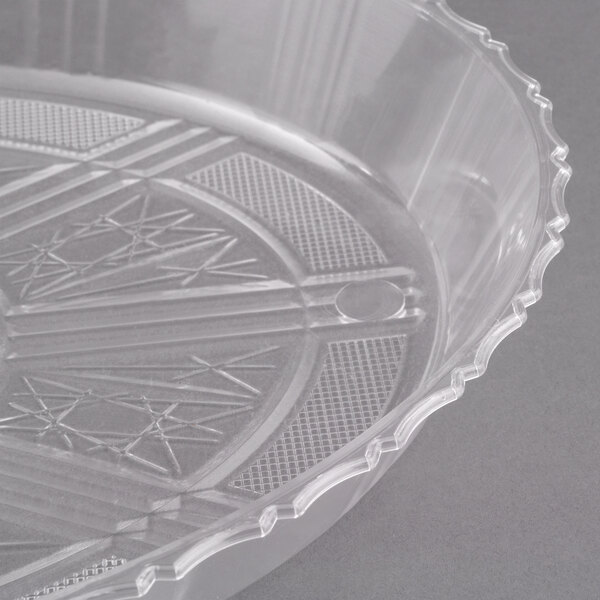 A clear plastic container with a scalloped edge.