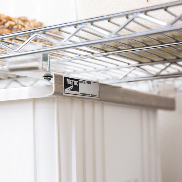 A Metro Super Erecta undershelf slide attached to a metal shelf.