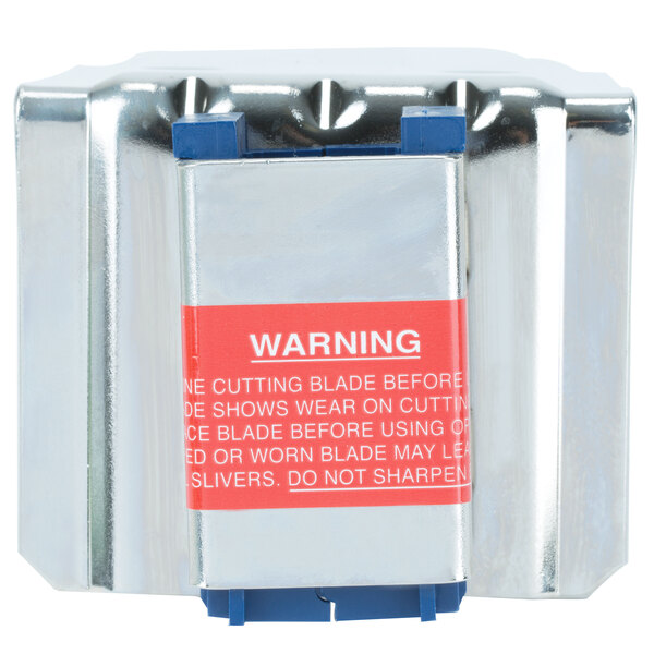 A metal box with a red label and a metal object inside.