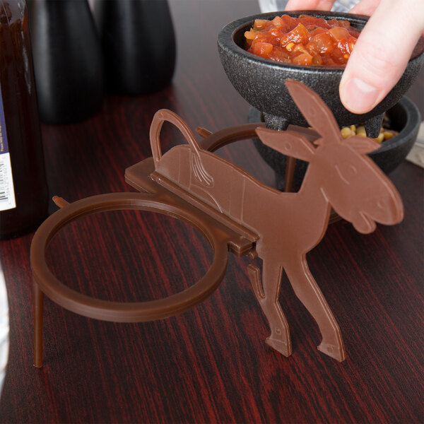 A brown polypropylene HS Inc. salsa caddy with a cartoon donkey on it.