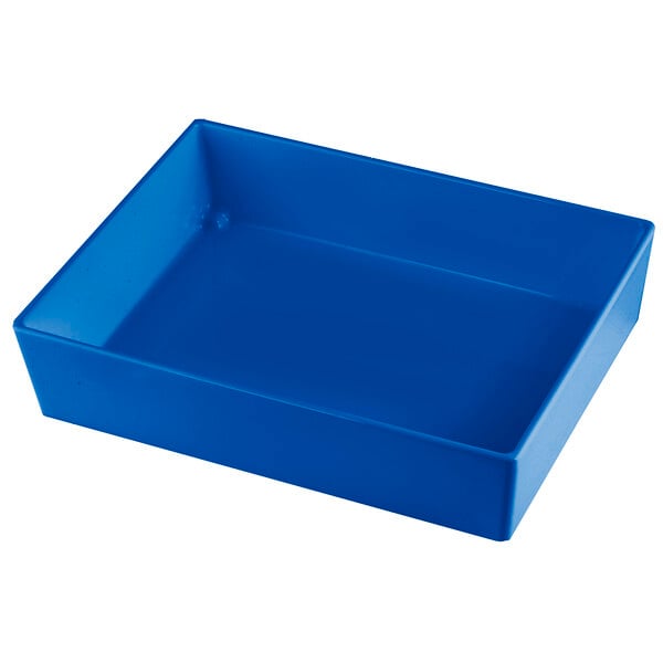 A Tablecraft cobalt blue cast aluminum rectangular bowl on a white counter.