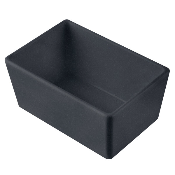 A black rectangular Tablecraft cast aluminum bowl with a blue speckle design on a counter.