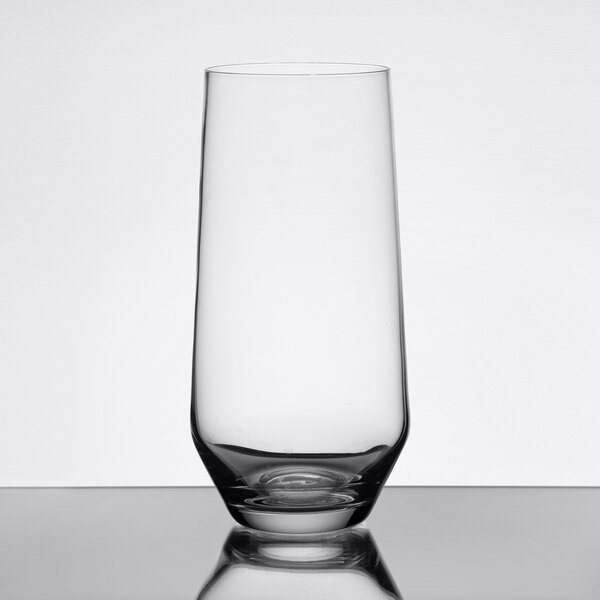 A Stolzle Revolution longdrink glass on a reflective surface.