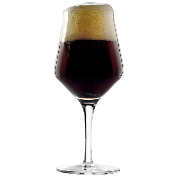 A Stolzle stemmed beer glass filled with dark beer.