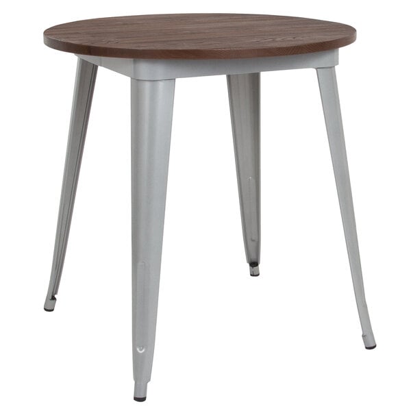 A Flash Furniture round dining table with a silver metal frame and walnut top.