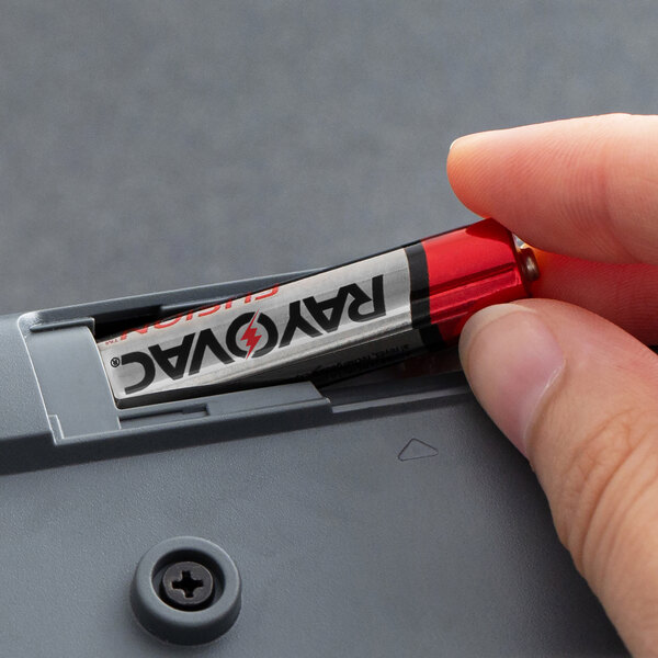 A hand holding a Rayovac Fusion AAA battery.