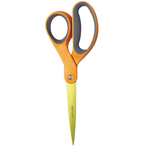 A close-up of Fiskars scissors with orange handles.