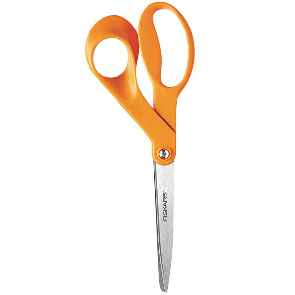 A close-up of a pair of Fiskars scissors with orange handles.